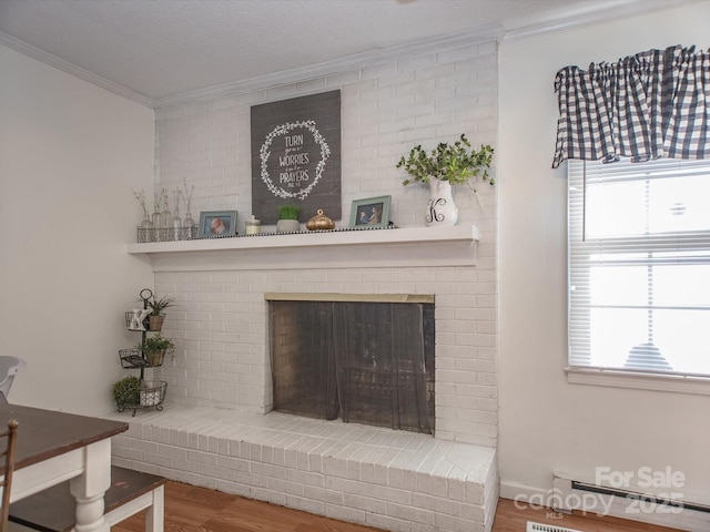 room details with visible vents, a fireplace, ornamental molding, and wood finished floors