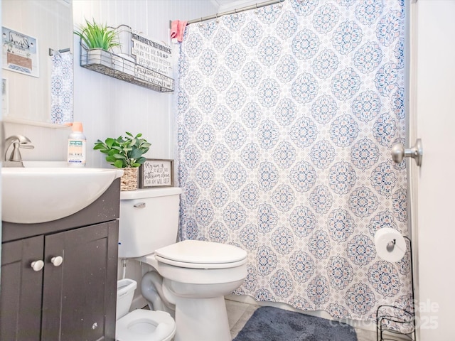 bathroom featuring vanity, curtained shower, tile patterned flooring, and toilet