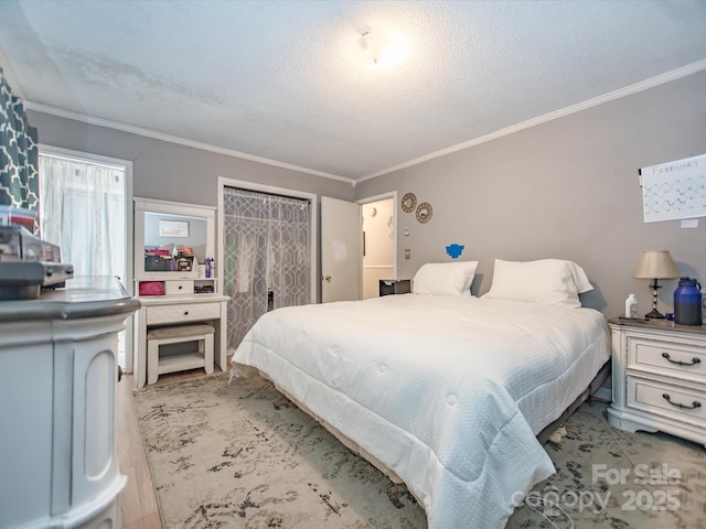 bedroom with a textured ceiling and crown molding