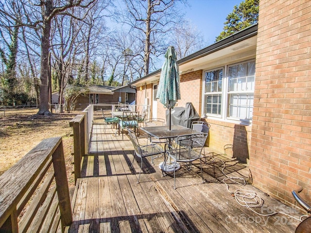 wooden terrace featuring outdoor dining space