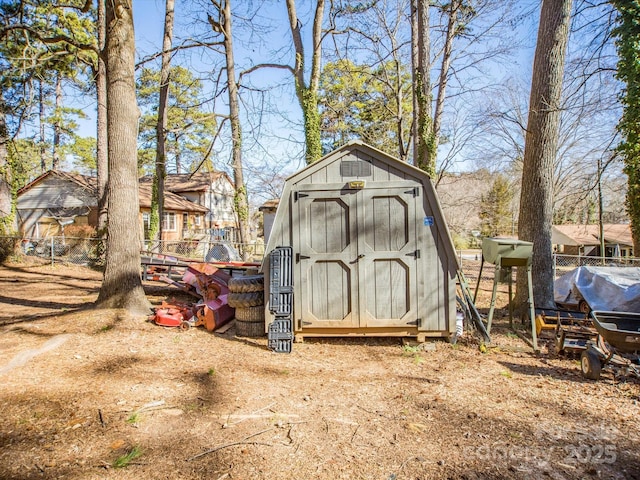 view of shed featuring fence