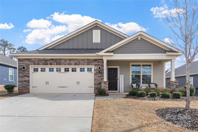 craftsman-style home with a porch, concrete driveway, board and batten siding, a garage, and stone siding