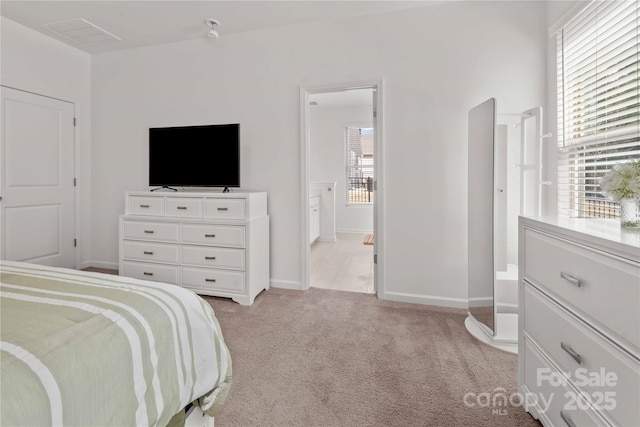 bedroom with baseboards and light colored carpet