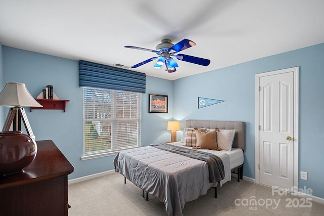 carpeted bedroom featuring visible vents, ceiling fan, and baseboards