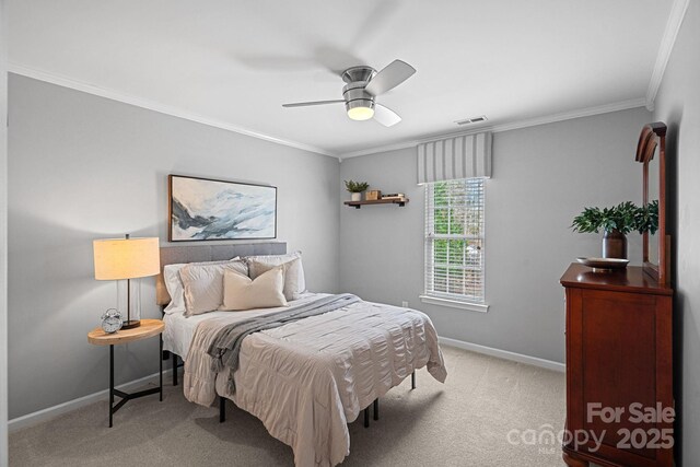 bedroom with light carpet, baseboards, visible vents, ceiling fan, and ornamental molding