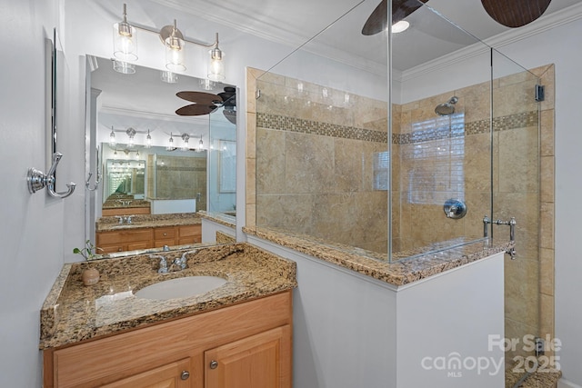 bathroom with ceiling fan, a stall shower, and crown molding