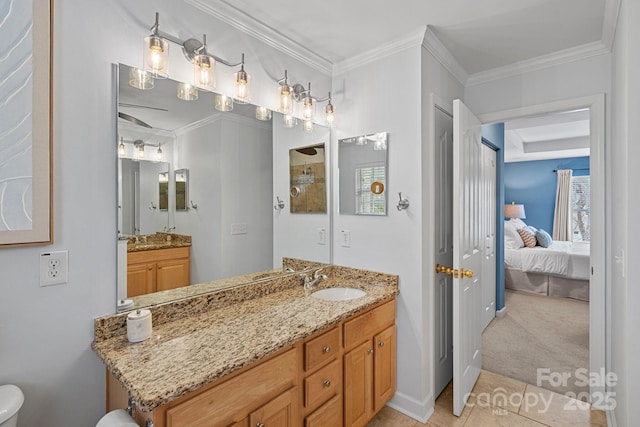 bathroom featuring tile patterned flooring, vanity, baseboards, ensuite bath, and crown molding