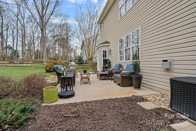 view of patio with fence, an outdoor hangout area, and central air condition unit