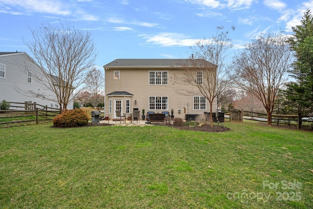 rear view of house featuring a patio, fence, and a lawn