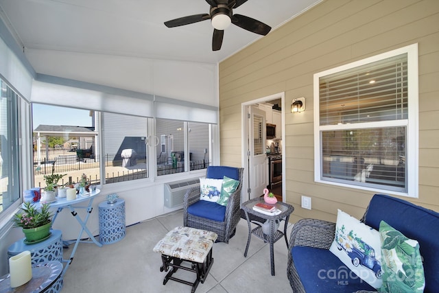 sunroom / solarium featuring ceiling fan, vaulted ceiling, and a wall mounted AC