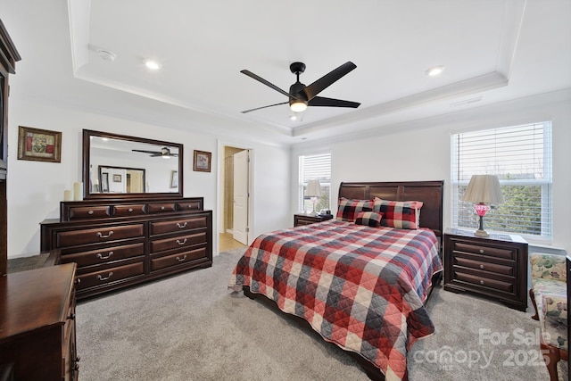 bedroom featuring light carpet, ceiling fan, a raised ceiling, and recessed lighting