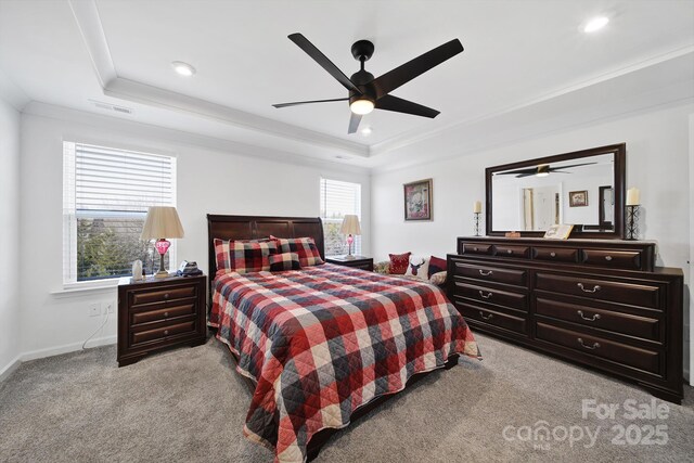 bedroom with ornamental molding, a tray ceiling, light carpet, and recessed lighting