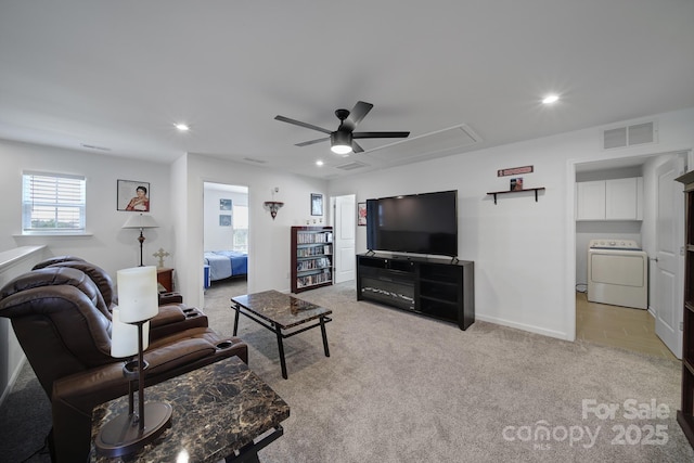 living room with light carpet, washer / dryer, attic access, visible vents, and recessed lighting