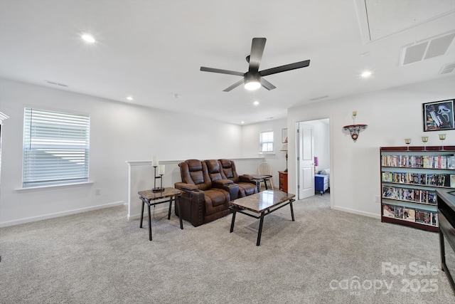 living room with light carpet, attic access, visible vents, and recessed lighting