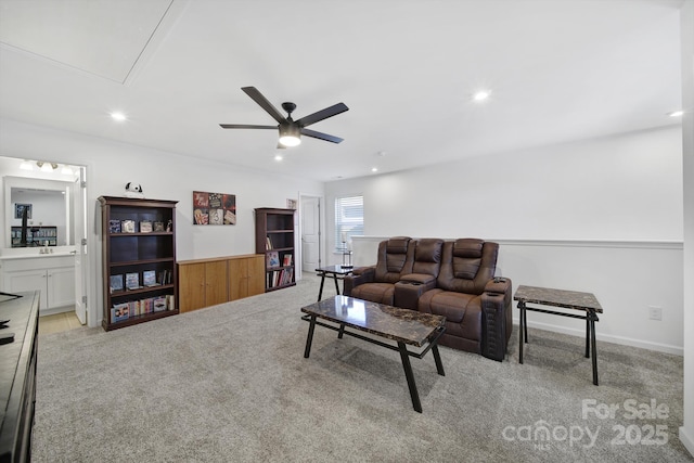 living area with light carpet, ceiling fan, attic access, and recessed lighting