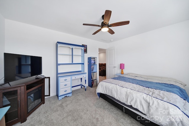 bedroom with light carpet and ceiling fan