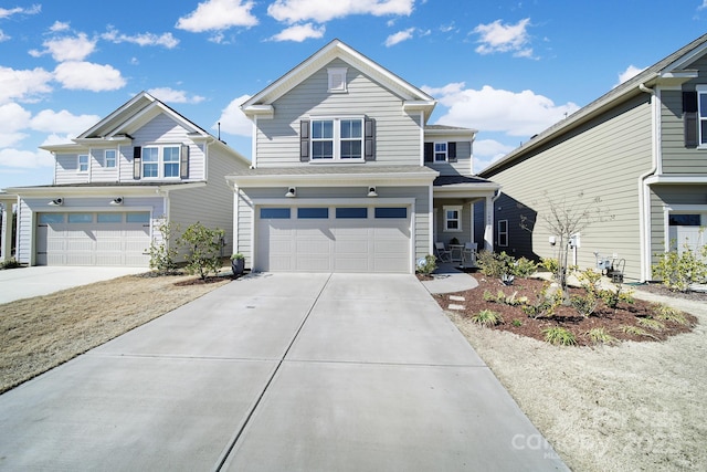 traditional-style home featuring a garage and concrete driveway