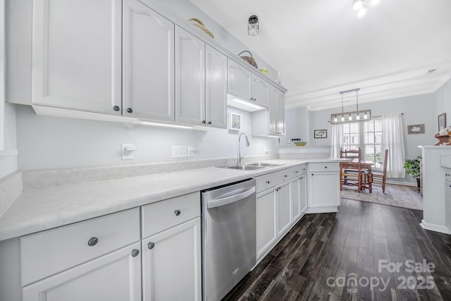 kitchen with light countertops, a sink, stainless steel dishwasher, and white cabinetry