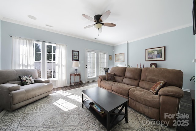 living area featuring ornamental molding, visible vents, ceiling fan, and wood finished floors