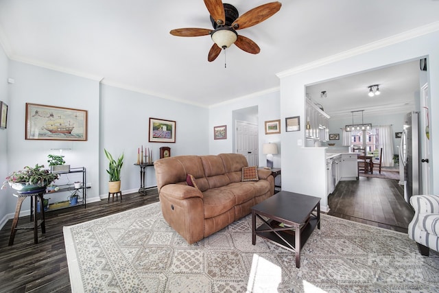 living area featuring ornamental molding, dark wood-style flooring, ceiling fan, and baseboards