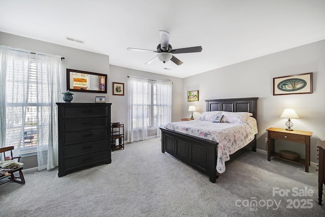 bedroom featuring baseboards, visible vents, and light colored carpet