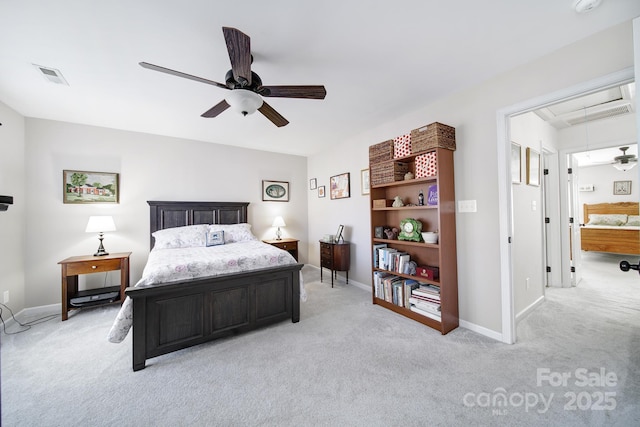 bedroom with light carpet, a ceiling fan, visible vents, baseboards, and attic access