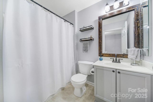 bathroom featuring tile patterned flooring, vanity, and toilet