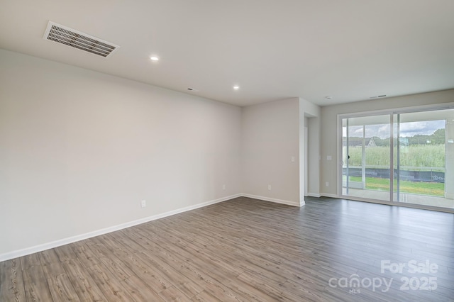 2656 Tillman St, Monroe, NC 28112 - spare room featuring wood finished floors, baseboards, and recessed lighting