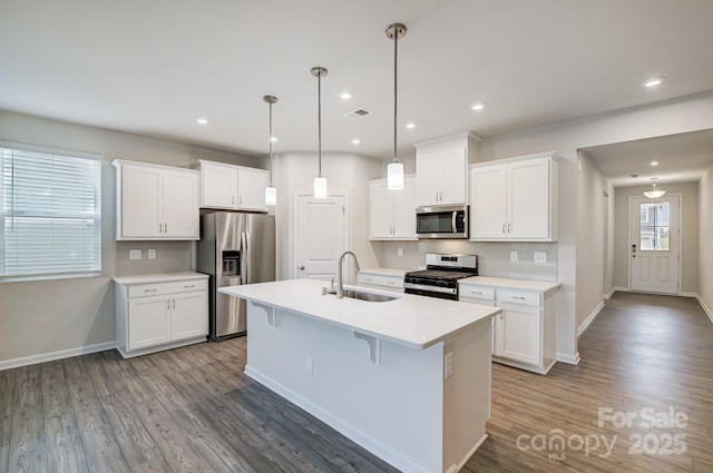 2656 Tillman St, Monroe, NC 28112 - kitchen with appliances with stainless steel finishes, a sink, wood finished floors, baseboards, and recessed lighting