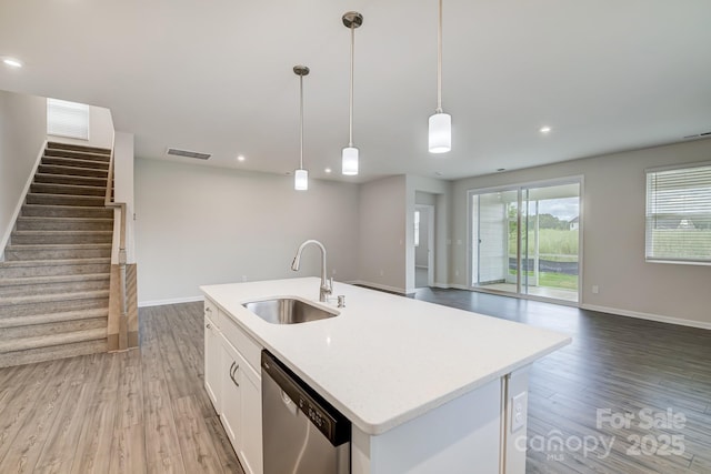2656 Tillman St, Monroe, NC 28112 - kitchen featuring a sink, dishwasher, light wood-type flooring, white cabinets, and an island with sink