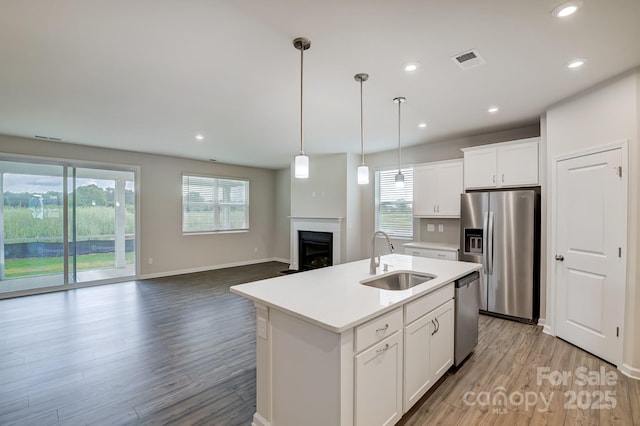 2656 Tillman St, Monroe, NC 28112 - kitchen featuring a sink, appliances with stainless steel finishes, healthy amount of natural light, a fireplace, and recessed lighting