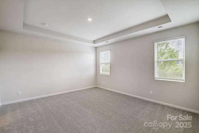 2656 Tillman St, Monroe, NC 28112 - empty room with a tray ceiling, carpet flooring, and baseboards