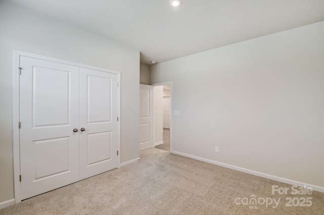2656 Tillman St, Monroe, NC 28112 - unfurnished bedroom featuring light carpet, baseboards, and a closet