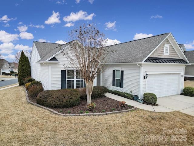 single story home featuring a standing seam roof, driveway, an attached garage, and a front yard