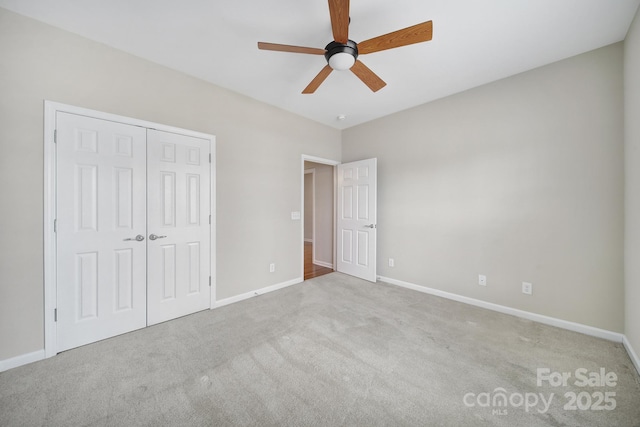 unfurnished bedroom with a closet, baseboards, and carpet