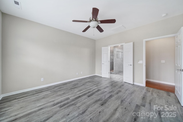 unfurnished bedroom featuring visible vents, ceiling fan, baseboards, and wood finished floors