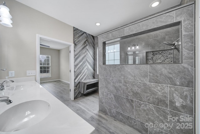 full bathroom with plenty of natural light, a walk in shower, and a sink