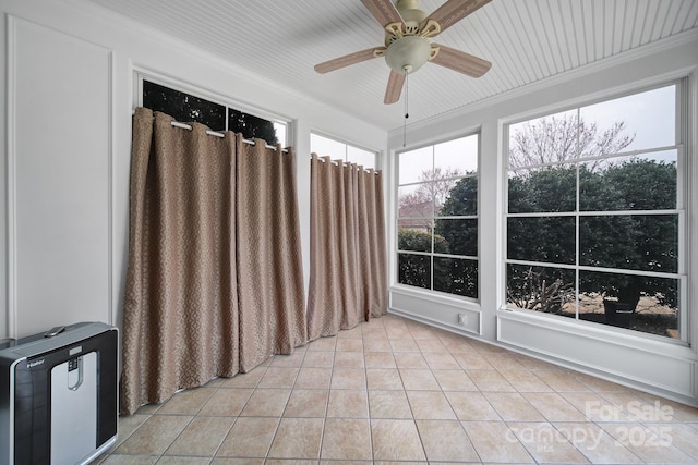 unfurnished sunroom with a ceiling fan