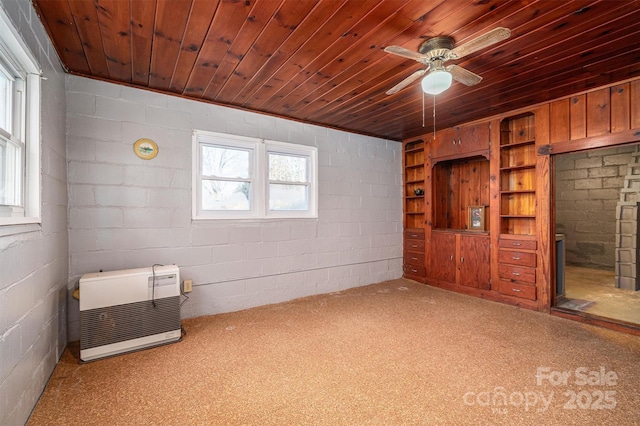 unfurnished room with ceiling fan, wood ceiling, and heating unit