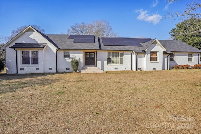 ranch-style home featuring brick siding, solar panels, entry steps, crawl space, and a front yard