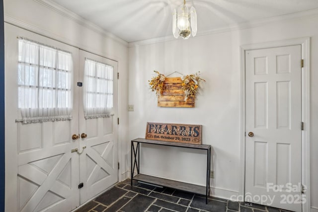 entryway with ornamental molding, french doors, brick floor, and baseboards