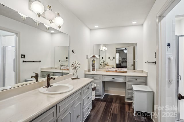 full bathroom with recessed lighting, a shower stall, vanity, and wood finished floors