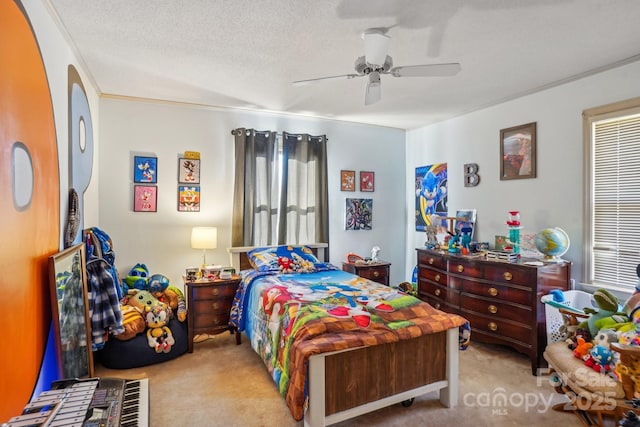 bedroom with a ceiling fan, a textured ceiling, and light colored carpet