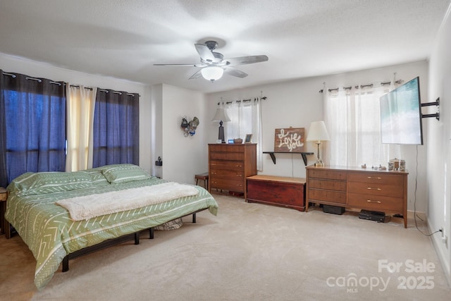 bedroom featuring light carpet and ceiling fan