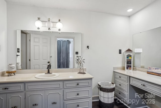 full bathroom featuring vanity and wood finished floors