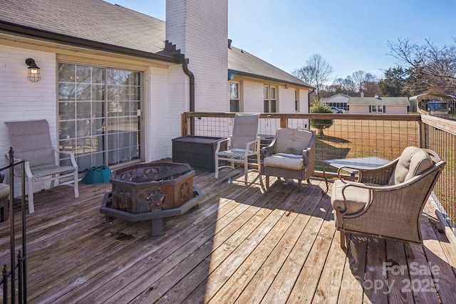 wooden deck featuring a fire pit