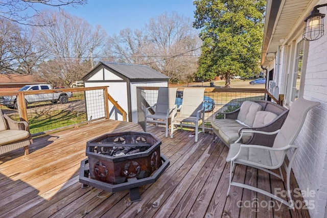 deck with an outbuilding and an outdoor living space with a fire pit