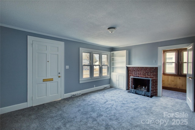 unfurnished living room with a fireplace, visible vents, ornamental molding, carpet flooring, and a textured ceiling