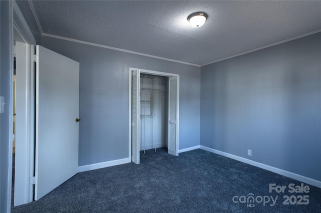 unfurnished bedroom with a textured ceiling, dark carpet, and crown molding