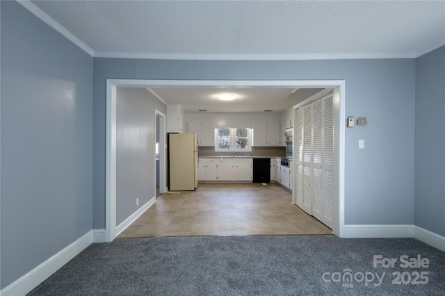 interior space with ornamental molding, light carpet, a textured ceiling, and baseboards